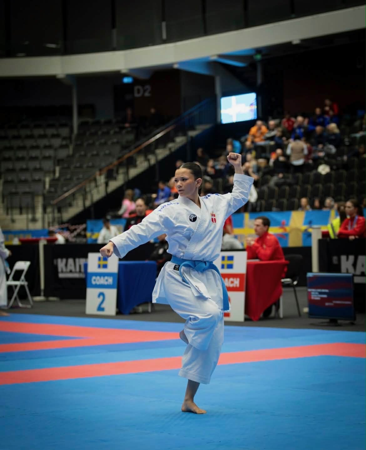 Freja Chung Jepsen performing kata in a large arena at an international karate championship